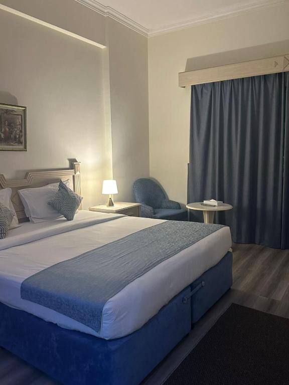 Double bed and seating in a room at the hotel